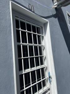 a white door with a window on a building at Kitnets Cidade de Goiás-Go 02 in Goiás