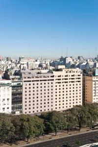 a large white building with a city in the background at NH Buenos Aires 9 de Julio in Buenos Aires
