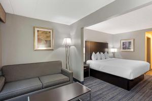 a hotel room with a bed and a couch at Best Western Plus Reading Inn & Suites in Reading