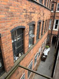a brick building with windows on the side of it at VIP 3BR Grade2 Luxurious Industrial House with WOOD FIRE, Electric blinds and big Cast iron Windows in the heart of the JQ in Birmingham