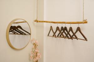 a mirror and a rack of hangers in a bathroom at Pallet Homes - Megaworld in Iloilo City
