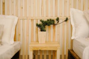 a table with a plant on it next to a bed at Pallet Homes - Megaworld in Iloilo City