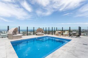 a swimming pool on the roof of a building at Kula Wollongong in Wollongong