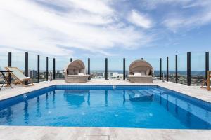 a swimming pool on the roof of a building at KULA Wollongong in Wollongong