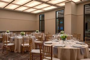a banquet hall with tables and chairs with flowers at Renaissance New York Chelsea Hotel in New York