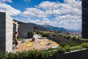a man standing on the roof of a house at Hermoso Loft en North Point in Bogotá