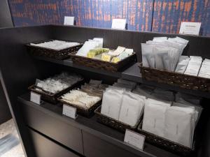 a store shelf filled with lots of white towels at KAMENOI HOTEL Kusatsu Yubatake in Kusatsu