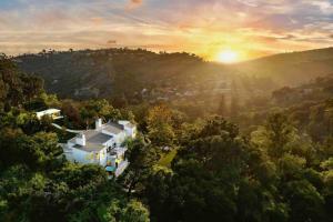 an aerial view of a house in the trees at The Glass House Montecito in Santa Barbara