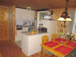 a kitchen with a table and a dining room at Holiday home Angel 2 in Warin