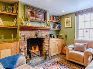 a living room with a fireplace and a tv at 3 Bed in Faversham 78880 in Faversham