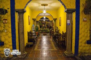 a hallway of a restaurant with yellow walls at Hotel Caxa Real in Comayagua