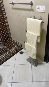 un baño con 3 toallas colgadas en un toallero en IMMO DYALI, en Taouima