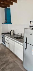 a kitchen with a stainless steel refrigerator and a sink at Departamento Los Cardales in Los Cardales
