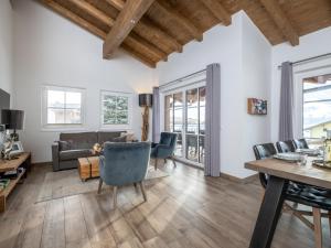 a living room with white walls and wooden ceilings at Luxury Tauern Suite Walchen Kaprun 8 in Angerberg