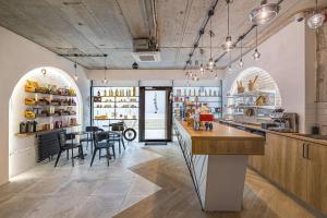 a kitchen with a bar and a dining room at Harmony Property WIN HERASTRAU in Bucharest
