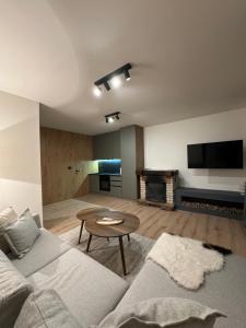 a living room with a couch and a table at Grandpa's Chalet Jahorina in Jahorina