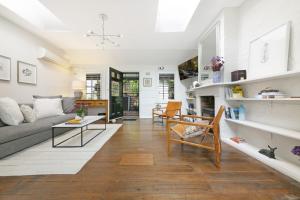 a living room with a couch and a table at Paddington Garden Cottage with fast Wifi in Sydney