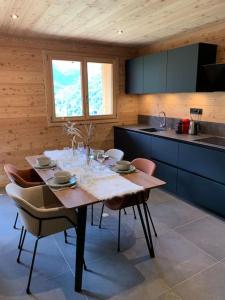 a kitchen with a table and chairs in a room at Superbe chalet avec vue montagne in Orcières