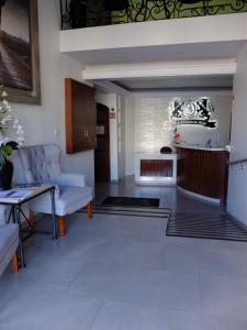 a living room with a couch and a table at Hotel Estancia Real in Tepatitlán de Morelos