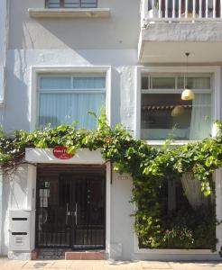 a white house with a black door and windows at Hotel Fegali Art Boutique in Cartagena de Indias