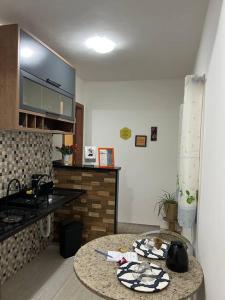 a kitchen with a counter and a table in a room at Pousada na fazenda! Venha descansar! in Serra