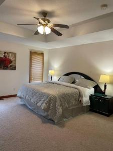 a bedroom with a bed and a ceiling fan at Urbandale Ranch in Urbandale +16 photos