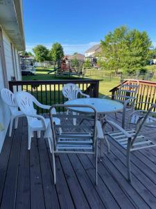 a table and chairs on a deck with a playground at Urbandale Ranch in Urbandale