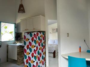 a kitchen with a refrigerator with hearts on it at Chalés Jardins dos Cajueiros in Tamandaré