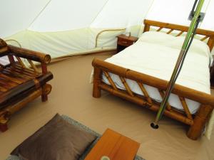 a room with two beds and a tent at Glamping La Isla Bonita (Isla Portete, Ecuador) in Zapotal