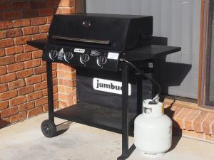 a grill on a cart next to a brick wall at Baudin House in Penneshaw