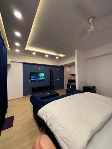 a bedroom with a bed and a flat screen tv at The Royal Residency Suites,Lucknow Gomti Nagar in Lucknow