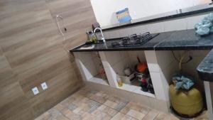 a kitchen with a stove and a counter top at Espaço lazer in Ribeirão Preto