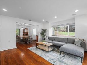 a living room with a couch and a table at Modern and Accessible 5 Bedroom Home in Wexford/Pittsburgh with Private Pool in Wexford