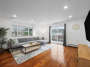 a living room with a couch and a table at Modern and Accessible 5 Bedroom Home in Wexford/Pittsburgh with Private Pool in Wexford