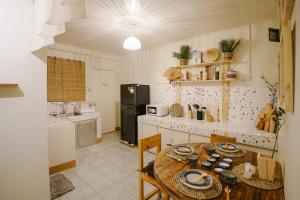 a kitchen with a wooden table and a refrigerator at Pallet Homes - Megaworld in Iloilo City