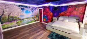 a bedroom with a bed and a mural at Americas Best Value Inn Providence-North Scituate in North Scituate