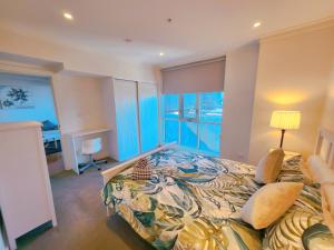 a bedroom with a large bed with a colorful bedspread at TAO-Dream of Rowlands in Adelaide