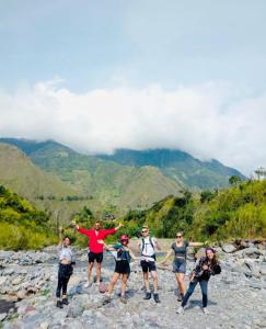 een groep mensen die op een rotsachtige berg staan bij Mama Tungu hostel in Baños