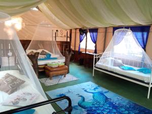 a room with two beds in a tent at Fully Furnished FAMILY JUNGLE TENT, Latino Glamping Paquera in Paquera