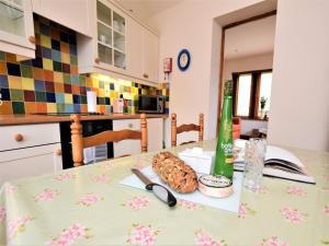 a table with a cake and a bottle on it at 1 bed property in Banbury CC072 in Shotteswell