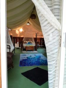 a room with a bed in a tent at Fully Furnished FAMILY JUNGLE TENT, Latino Glamping Paquera in Paquera