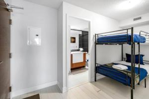a bedroom with two bunk beds and a bathroom at One Bed and Den Upscale Comfort Condo with Parking in Toronto