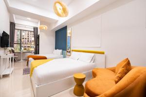 a hotel room with a bed and a couch at Genius Apartment River Gate Free Pool in Ho Chi Minh City