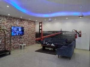 a room with couches and a wall with a tv at سحاب فيو in Abha +7 photos