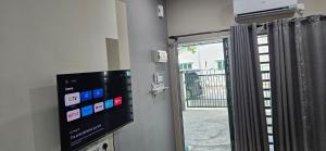 a room with a window with a television and a window at Teluk Intan Homestay Landed 3BR2B in Teluk Intan