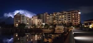 a large building with boats in a marina at night at Marina Inn at Grande Dunes in Myrtle Beach