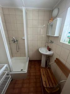 La salle de bains est pourvue d'une douche, d'un lavabo et d'un banc. dans l'établissement Chatka Janka - Malowniczy domek w Beskidach, à Sopotnia Wielka