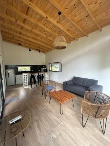 a living room with a blue couch and a table at Sombras del Pinar in Necochea +12 photos