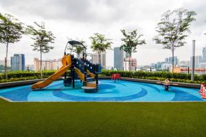 a playground in a park with a slide at Nadi Bangsar by Plush in Kuala Lumpur