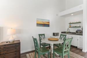 a kitchen with a table and chairs in a kitchen at Romantic Getaway - Luxury Oceanfront Studio - Private Balcony - Fireplace in Oceanside